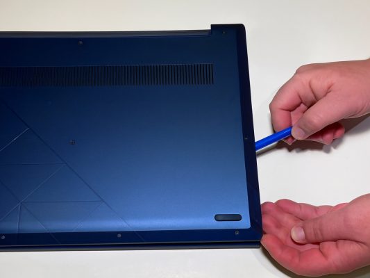Using a spudger to open laptop case